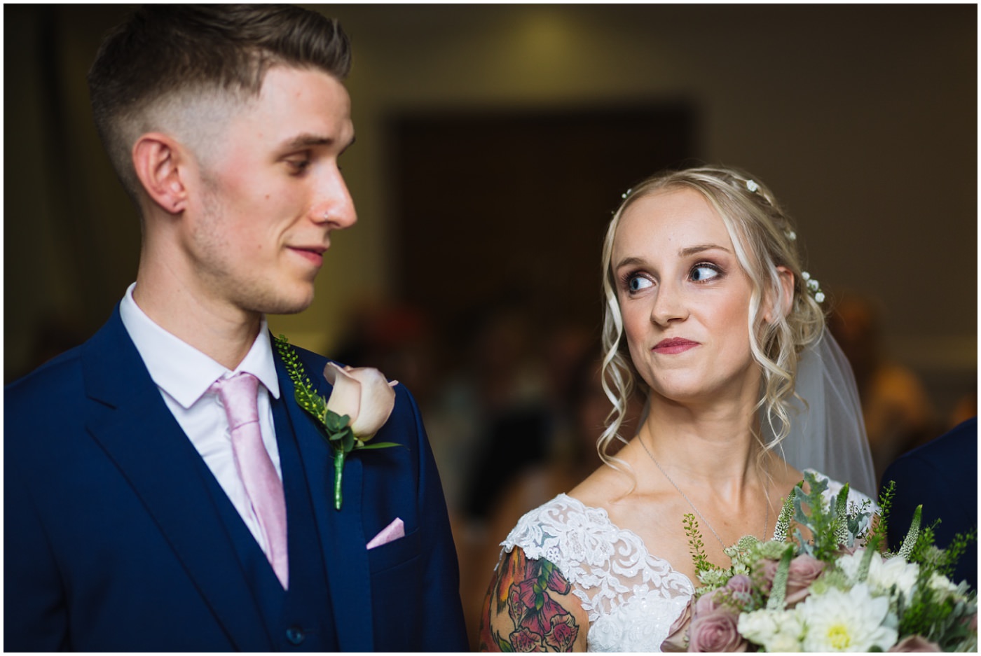 bride and groom share a look during wedding ceremony