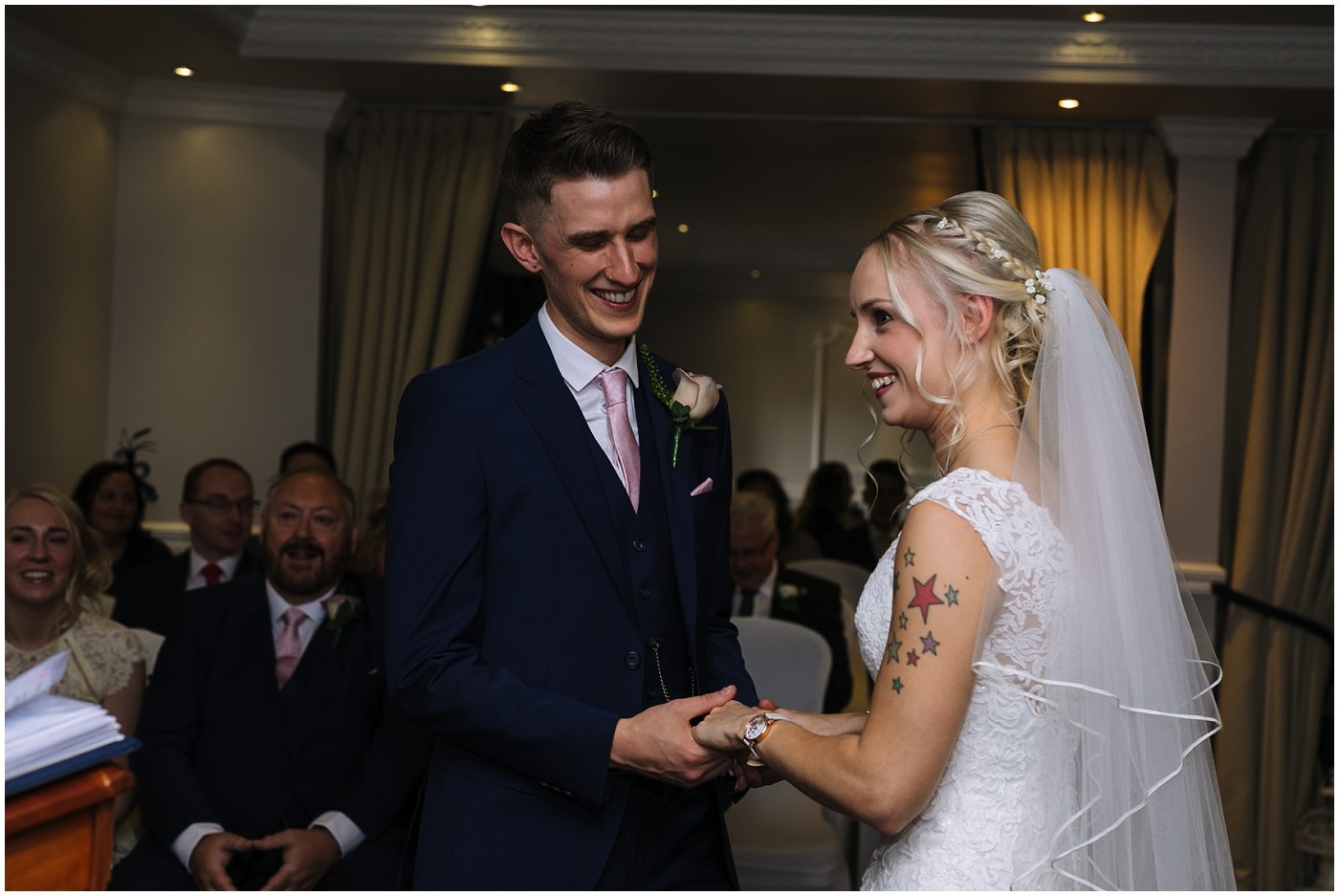 bride and groom smile during wedding ceremony