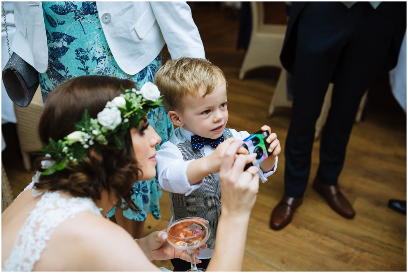 bride and son play with disposable camera