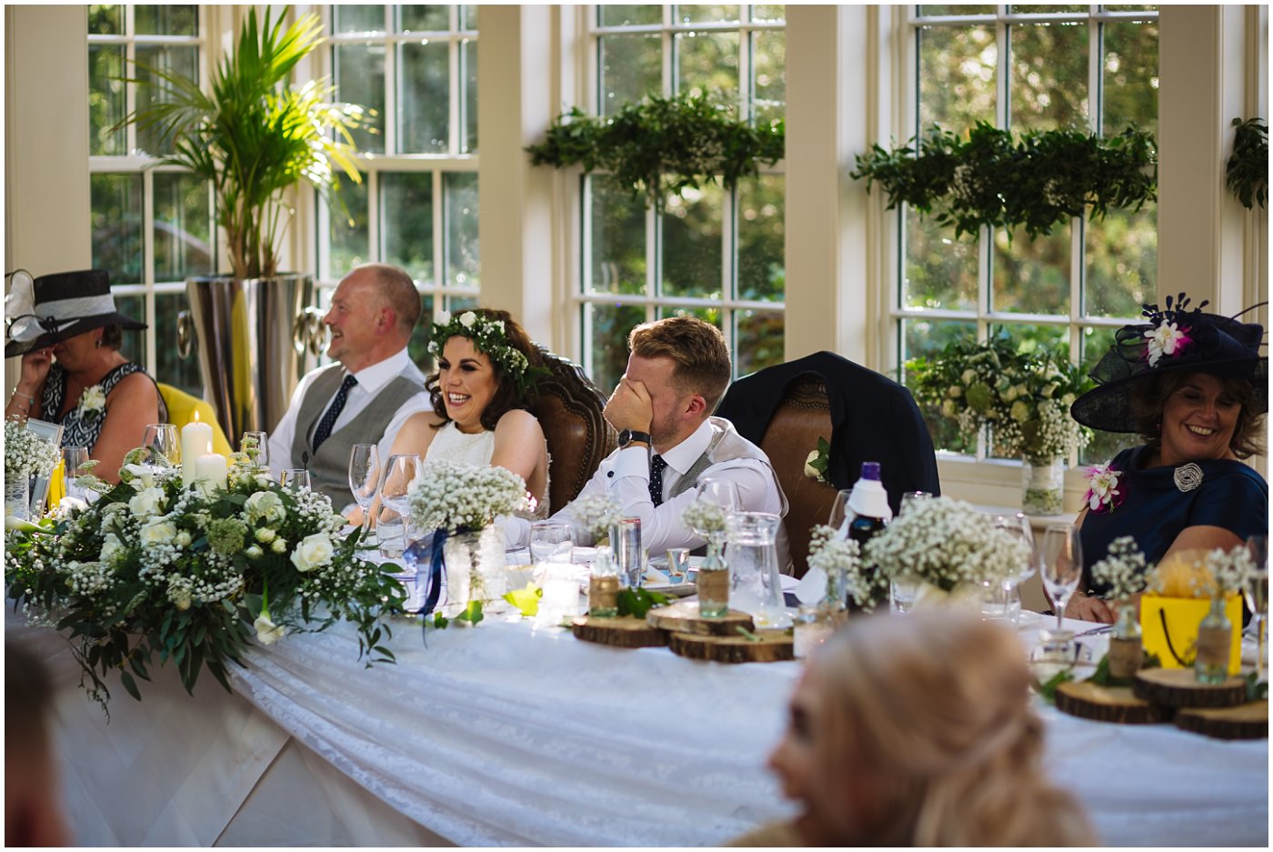 groom hides his face in reaction to best mans speech