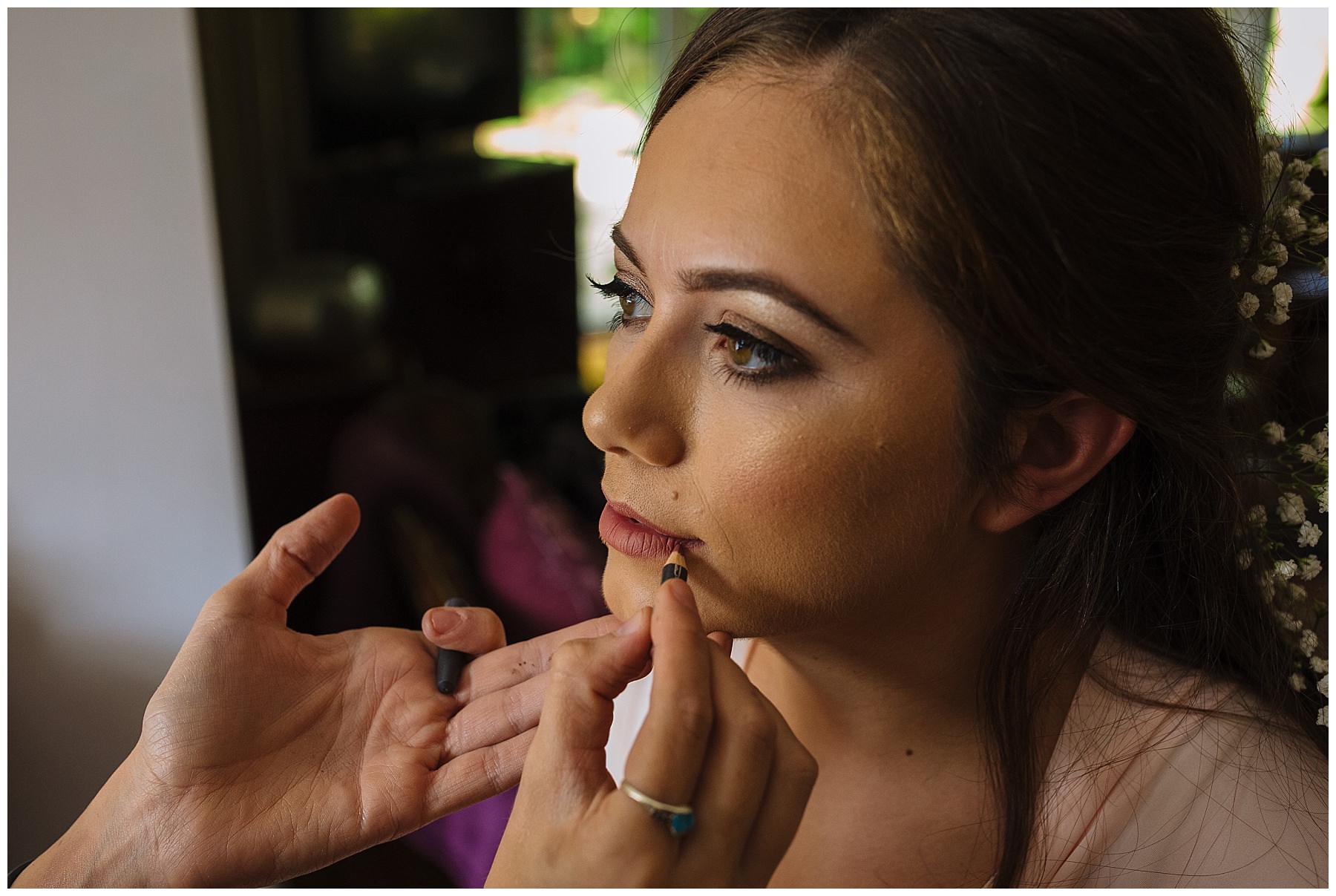 make up artist applies bridal lip liner