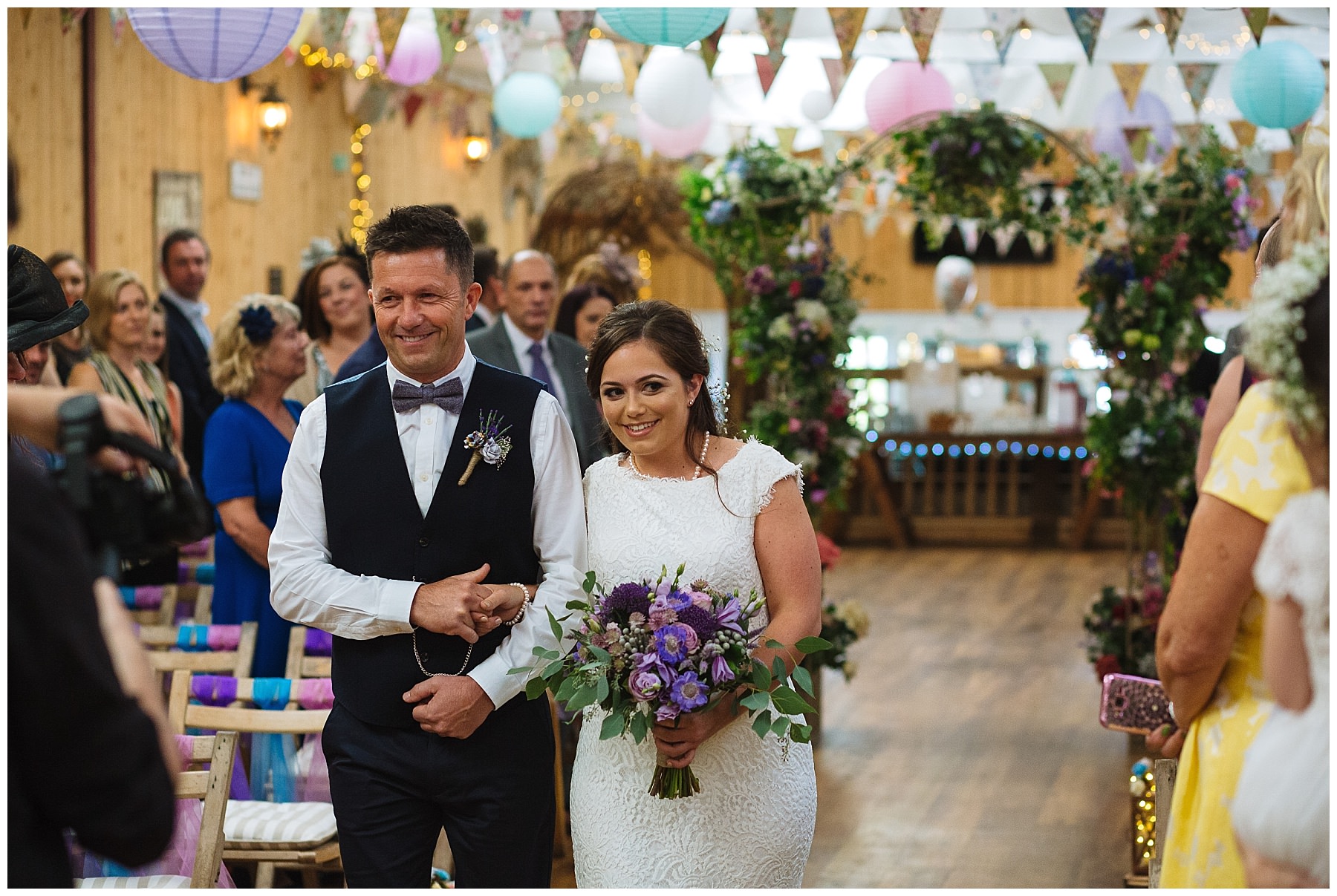 bride and father walk down the isle at the wellbeing farm