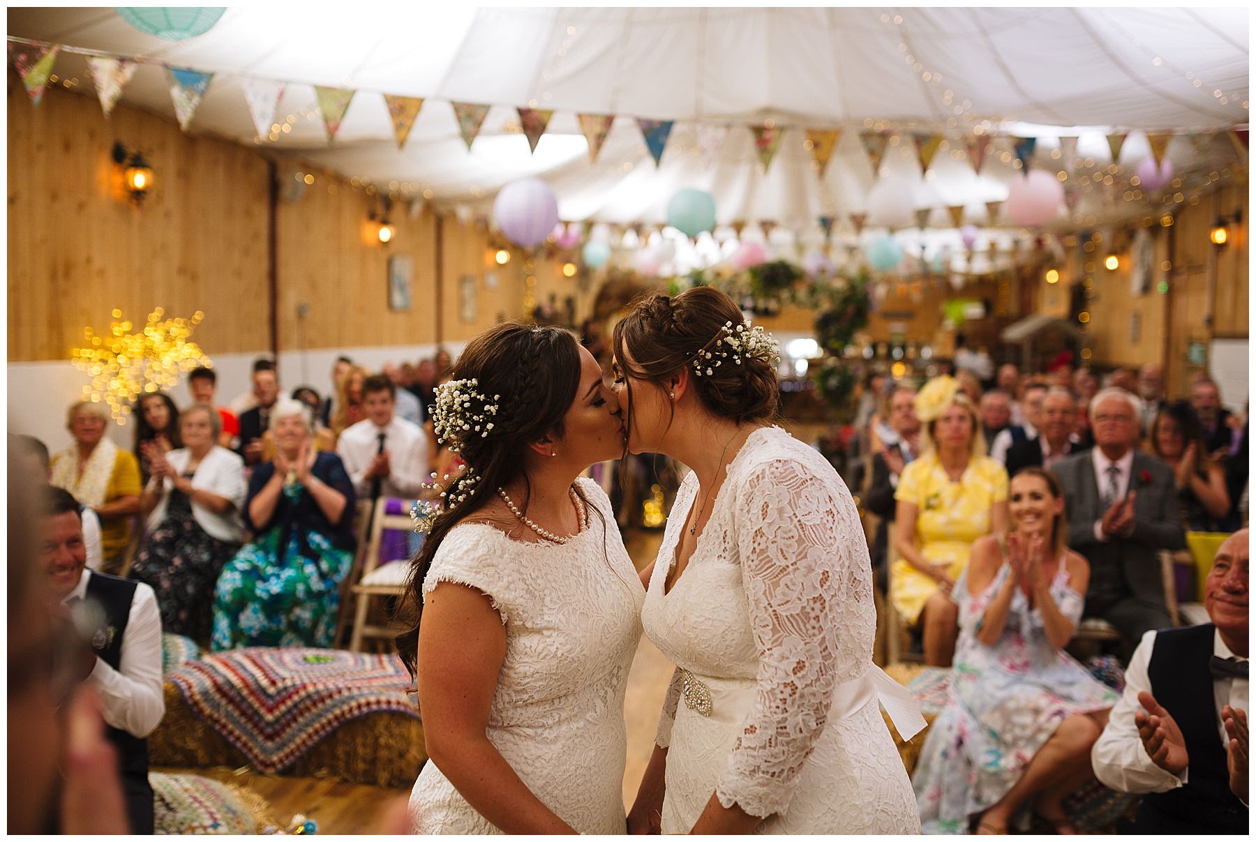 brides kiss during same sex wedding service