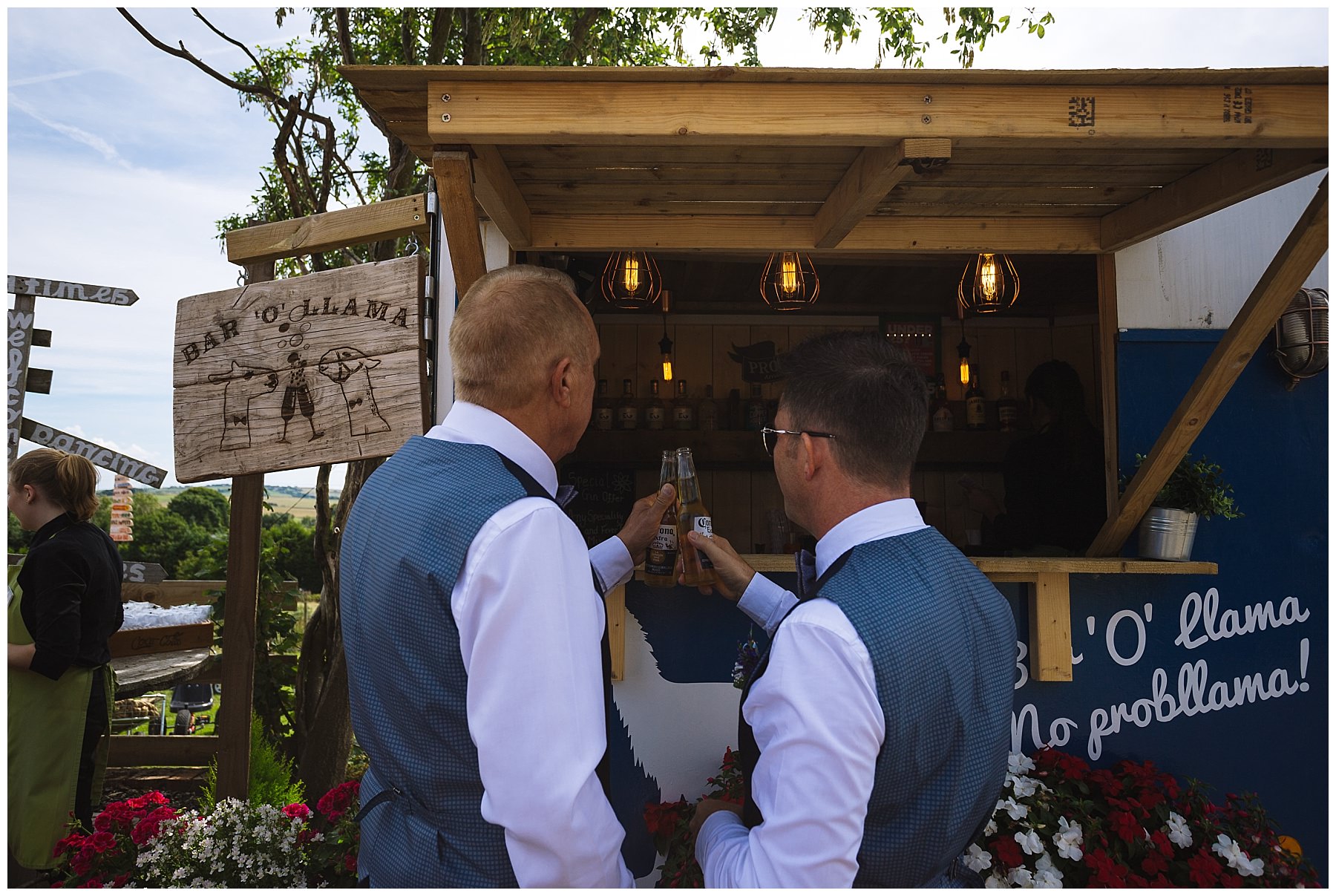 two dads share a beer after wedding ceremony