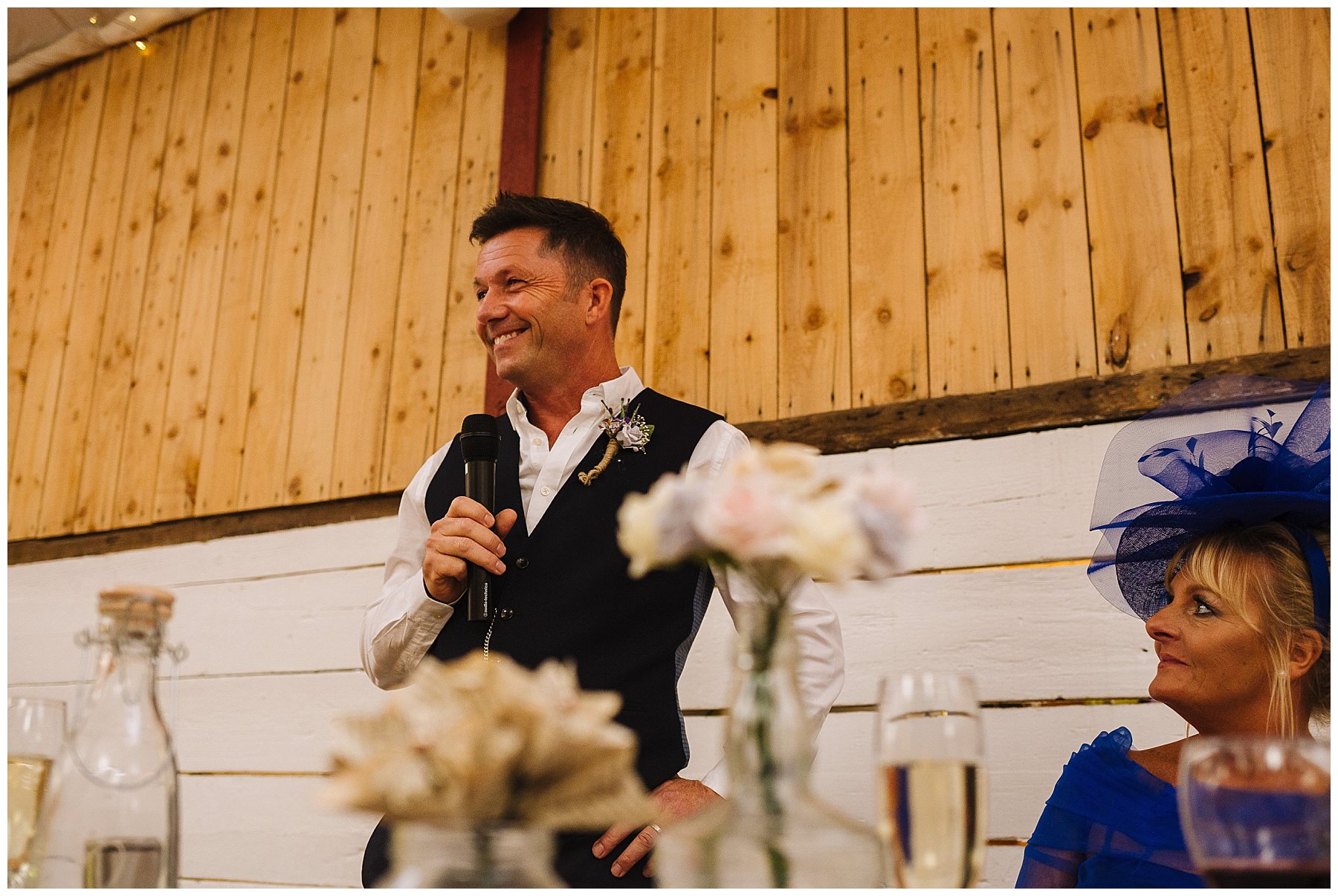 Father of the bride stands proud to speak at daughters wedding