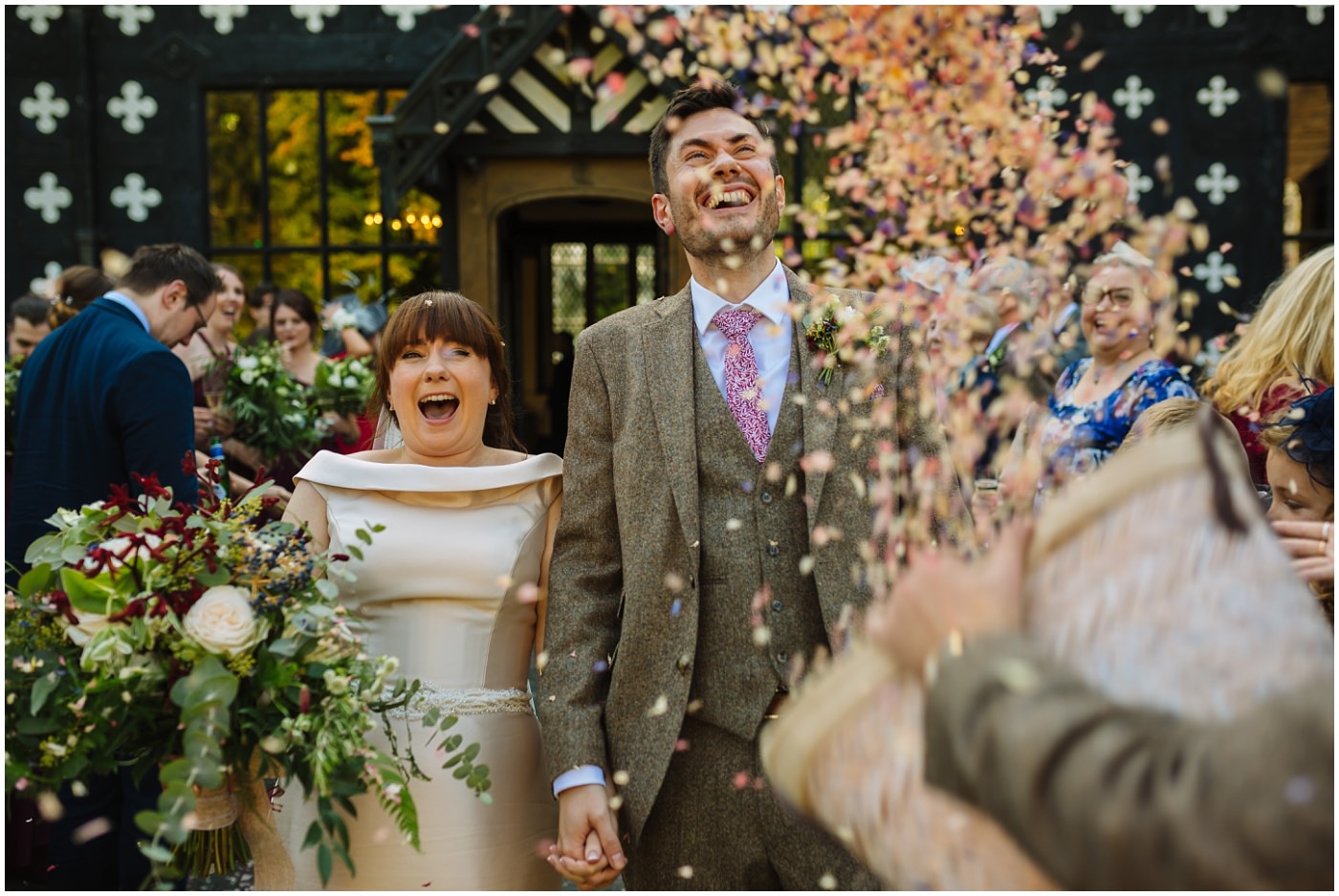 buckets of confetti thrown over bride and groom leaving samlesbury hall