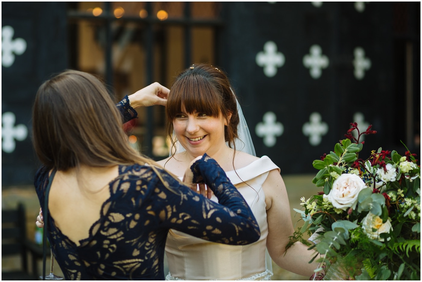 bride has confetti picked from her hair at samlesbury hall wedding