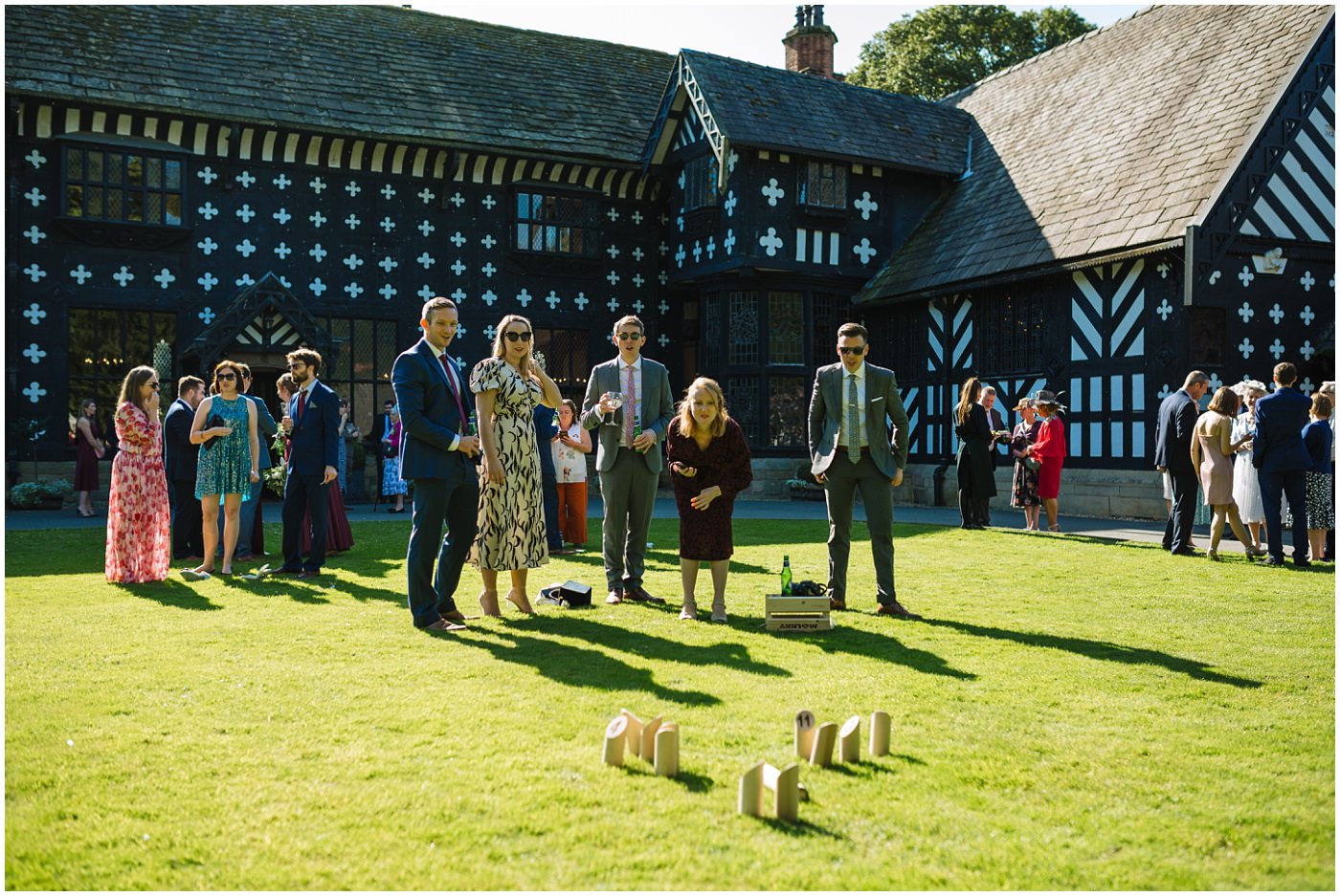 guests enjoy garden games on the lawns at samlesbury hall wedding