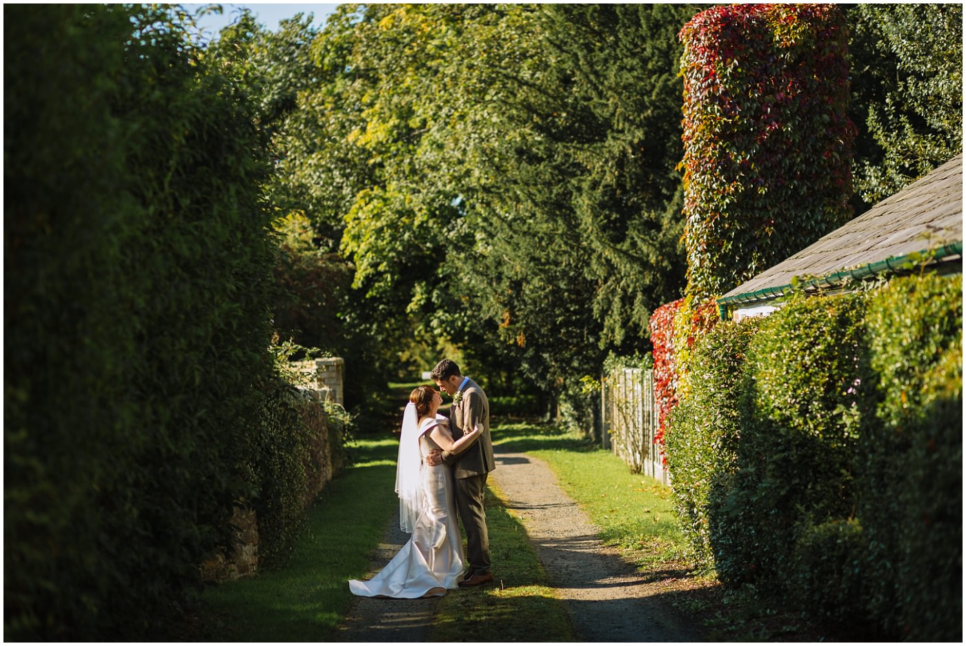 wedding couple pose in country lane at samlesbury hall