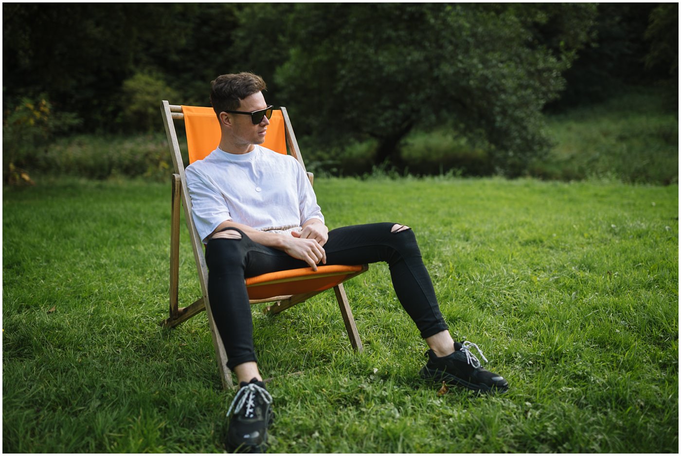 Joel Corry sits in an aperol spritz deck chair at uk's first socially distanced festival