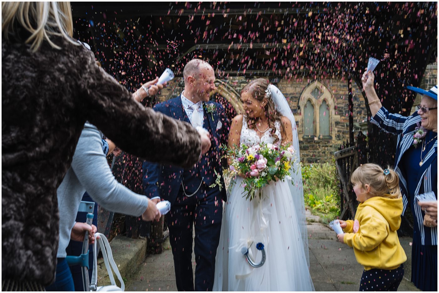 Confetti on bride and groom at Shireburn Arms Wedding