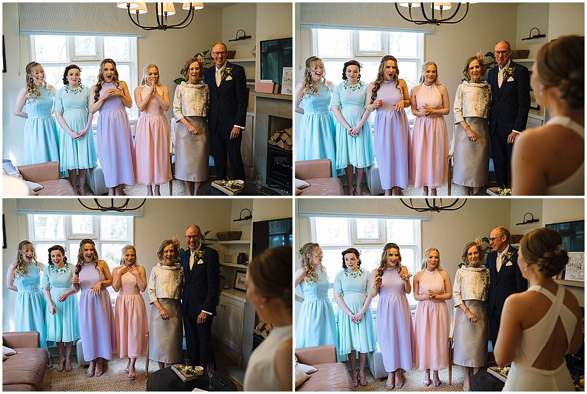 A collage of four images depicting emotional moments during a wedding preparation in a living room. In the top two images, four bridesmaids in pastel blue and pink dresses watch someone off-camera with expressions of surprise and delight; an older woman and a man in a suit with a boutonniere join them in the top right image. The bottom two images capture the group laughing joyfully and the older couple smiling at someone off-camera, likely the bride, considering the wedding context.